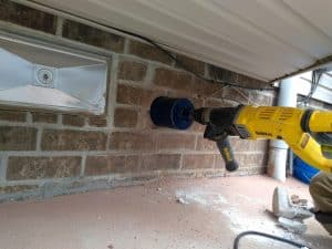 cutting a hole through brick wall for dryer vent reroute 300x225